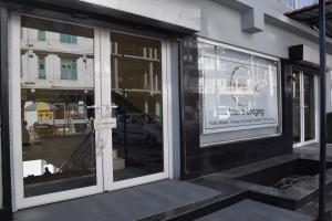 a store front with glass doors with a sign on it at The Khaar in Tawang