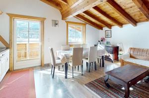 a kitchen and dining room with a table and chairs at Gipfelblick Appartements in Umhausen
