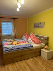 a bedroom with a bed with pillows and a window at Bergblick in Saupsdorf