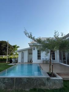 a house with a swimming pool in the yard at Stayokay Sattahip ที่พักสัตหีบ in Sattahip