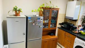 a kitchen with a refrigerator with magnets on it at A cosy & peaceful homestay in Sutton