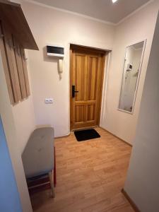 a hallway with a door and a wooden floor at Welcome Valmiera in Valmiera