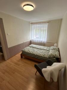 a small bedroom with a bed and a window at Welcome Valmiera in Valmiera