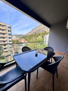 a table and chairs on a balcony with a view at Marbel Sea View in Shëngjin