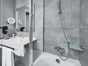 a bathroom with a shower and a sink at Novotel Kraków Centrum in Krakow