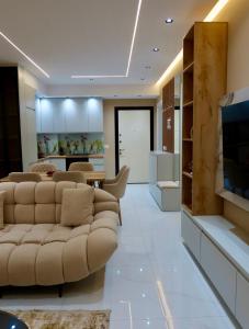 a living room with a couch and a television at Marbel Sea View in Shëngjin