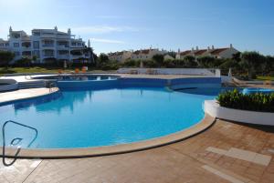 a large pool with blue water in a resort at Vilamoura Apartment in Vilamoura