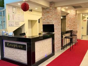 a reception desk in a lobby with a red carpet at Holiday Hotel in Erdemli