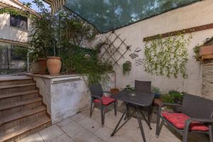 a patio with a table and chairs and plants at Punta Debij Select Apartments in Punat +32 photos