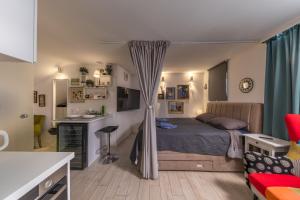 a bedroom with a bed and a desk in it at Punta Debij Select Apartments in Punat