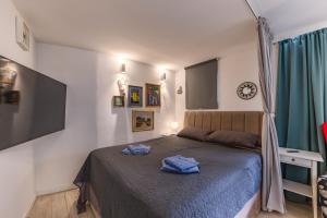 a bedroom with a bed with blue towels on it at Punta Debij Select Apartments in Punat