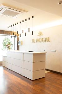 a lobby with a reception desk and a hospital sign at Hotel El Nogal in Peligros