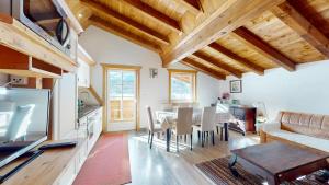 a kitchen and living room with a table and chairs at Gipfelblick Appartements in Umhausen