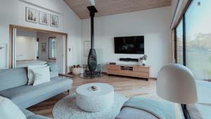 a living room with a couch and a tv at Denmark Scenic Tourist Park in Denmark