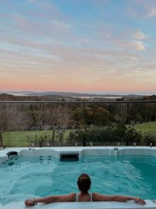 a man sitting in a swimming pool looking at the view at Denmark Scenic Tourist Park in Denmark