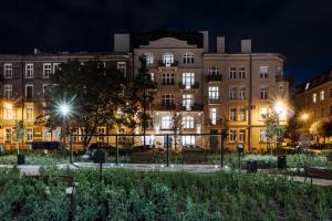 a building at night with lights in front of it at Hotel M4 Boutique in Krakow