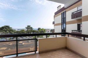 an apartment balcony with a view of a city at Estoril Riviera Residences in Estoril