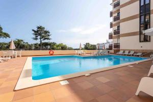 a swimming pool on the roof of a building at Estoril Riviera Residences in Estoril