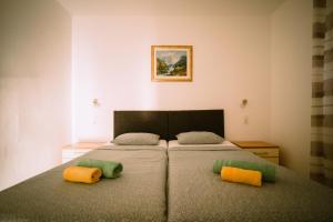 a bedroom with a bed with two pillows on it at Stars in Gornji Karin