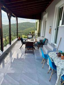 a patio with a table and chairs on a balcony at AnnaPolys House in Kavála