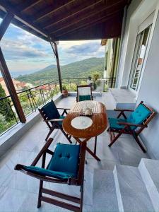 a patio with a table and chairs on a balcony at AnnaPolys House in Kavála