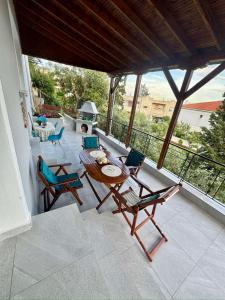 a patio with a table and chairs and a grill at AnnaPolys House in Kavála