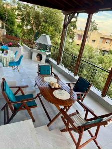 a patio with a table and chairs and a grill at AnnaPolys House in Kavála +29 photos