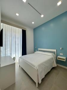 a bedroom with a bed and a blue wall at I Colori della Bellezza in Gragnano +15 photos