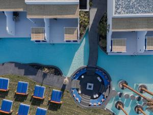 an overhead view of a swimming pool with blue chairs at Cresanto Luxury Suites in Imerovigli
