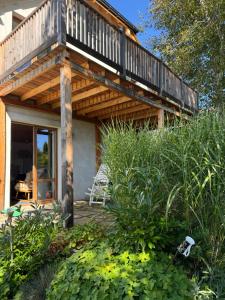 a wooden house with a balcony in the garden at Istebna 401 MURY in Istebna