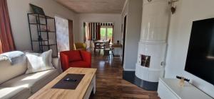 a living room with a couch and a table at Michel-Inn-Your Scandinavian Escape! in Faggemåla