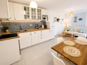 a kitchen and living room with a table and chairs at La Maya in Caleta De Fuste