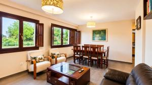 a living room with a couch and a table at Villa Los Bufones de Pria in Llames de Pría