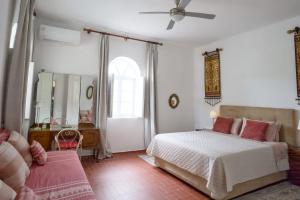 a bedroom with a bed and a ceiling fan at Artistic Villa Aqua Ios in Ios Chora