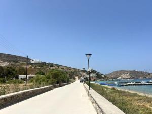 a road next to a river with boats on it at Artistic Villa Aqua Ios in Ios Chora