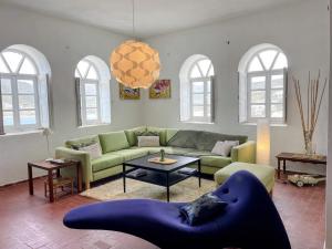 a living room with a couch and a table at Artistic Villa Aqua Ios in Ios Chora