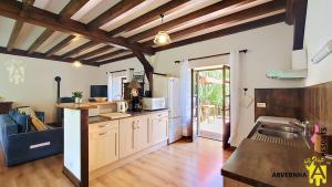 a kitchen with a sink and a counter top at Gîte Scopa in Murol