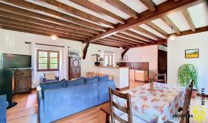 a living room with a blue couch and a table at Gîte Scopa in Murol