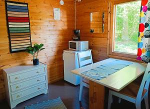 a small kitchen with a table and a microwave at Tampere Camping Härmälä in Tampere