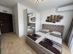 a bedroom with a bed and a mirror at VP Onyx Apartment in Elenite
