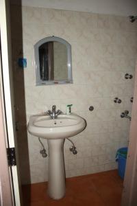 a bathroom with a sink and a mirror at Hotel reegyal in Ravangla