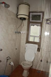 a small bathroom with a toilet and a window at Hotel reegyal in Ravangla