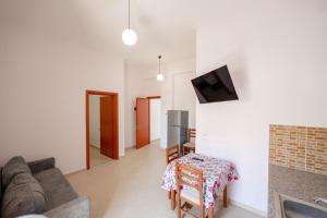 a living room with a couch and a table at Center Apartments in Ksamil