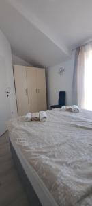 a bedroom with two large beds and a window at Apartment Mali Mol in Vantačići