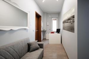 a living room with a couch and a picture on the wall at La Palazzata Urban Suites in Messina