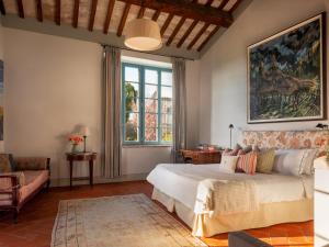 ein Schlafzimmer mit einem Bett und einem großen Fenster in der Unterkunft Borgo Pignano Volterra Tuscany in Pignano + 118 Fotos