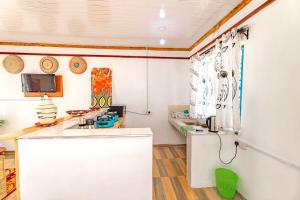 a kitchen with a white counter and a refrigerator at Chakruok Gardens, Hawi in Bondo