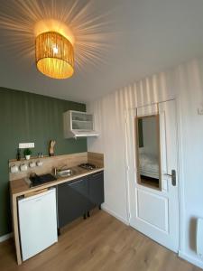 a kitchen with a sink and a light at Au6bis in Givet