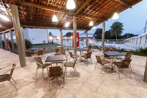 a group of tables and chairs on a patio at Hotel SESI PB - Parque da Mata in Rio Tinto