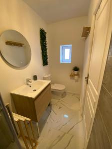 a bathroom with a sink and a mirror and a toilet at Au6bis in Givet
